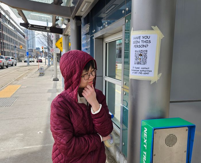 Jen smirking at and admiring the posters we put up at Central ION station.