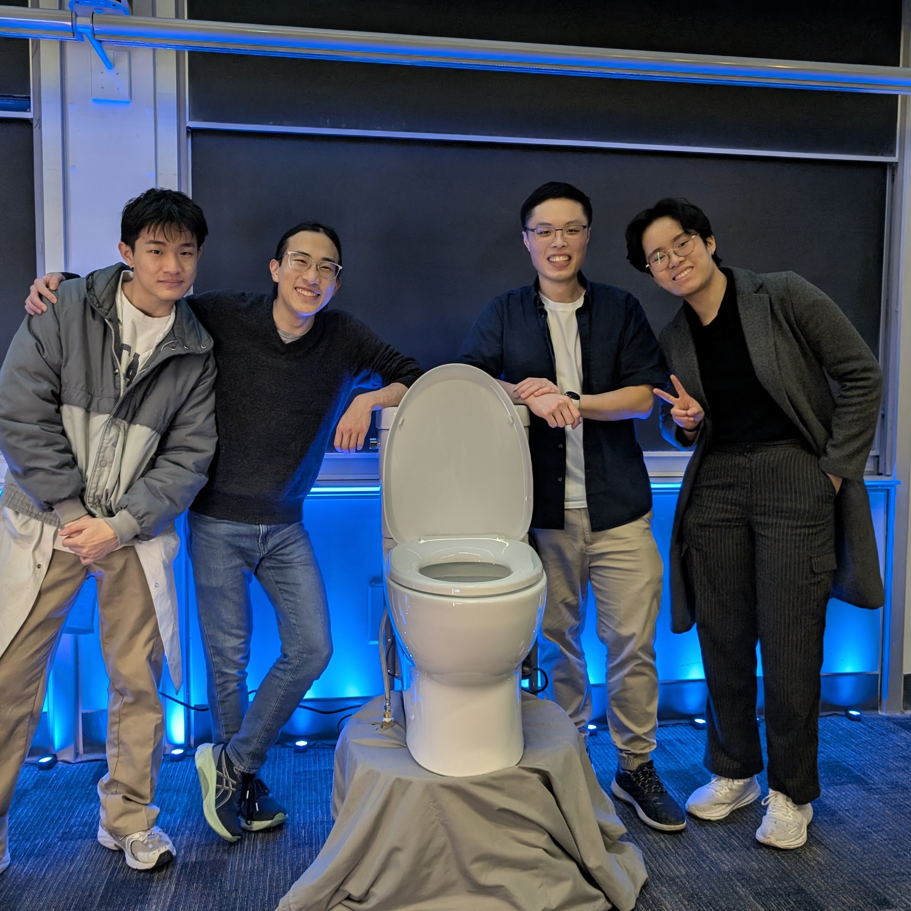 The first version of Orbital Flush, with Bill, Kai, Calvin, and Chloe posing next to it.